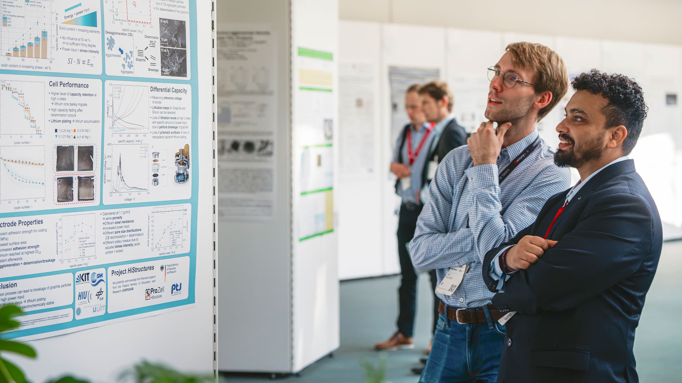 Experts looking at a scientific congress poster