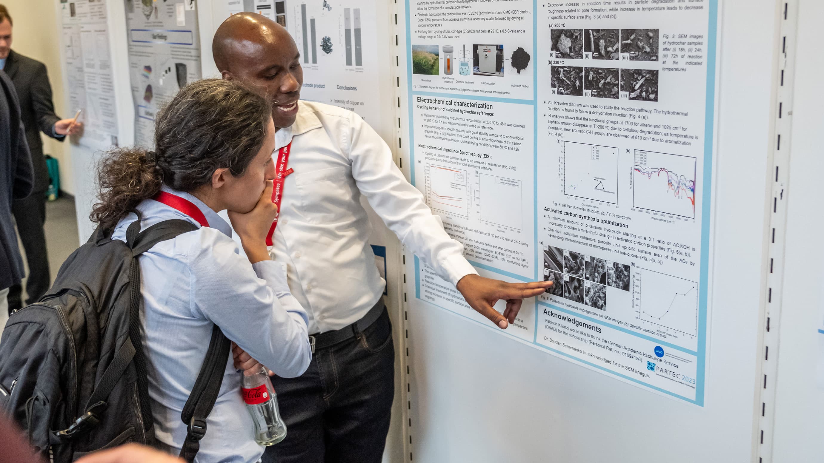 Expert explaining a specific topic on a scientific poster